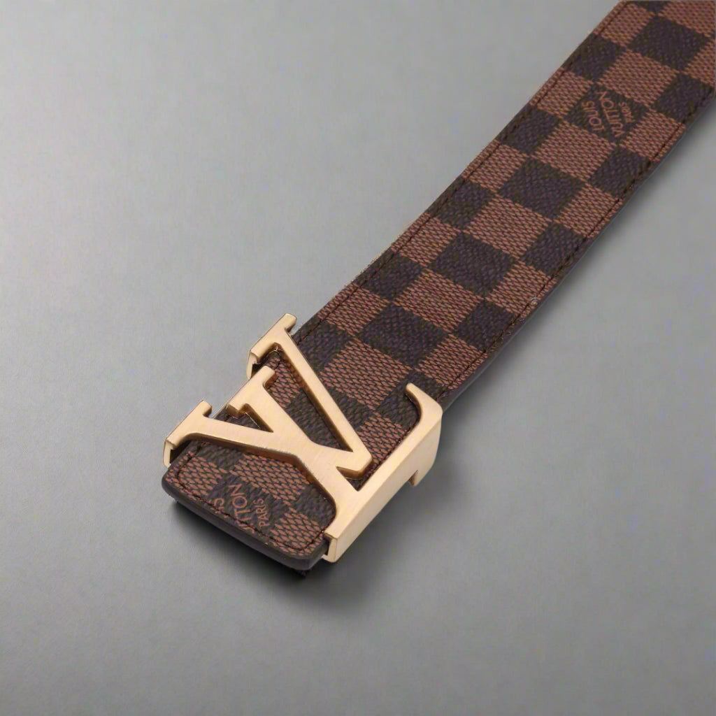 Brown checkered belt with gold buckle on a gray background